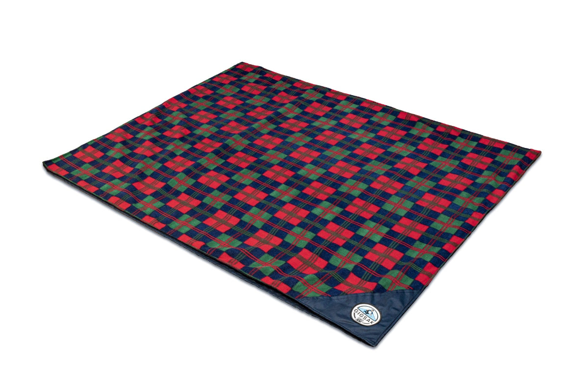 A GIGSAK outdoor waterproof blanket is the only outdoor waterproof blanket you can sit inside. It features a sleek red, green, and blue tartan with a blue waterproof design. GIGSAK features a unique, hidden, cosy shelter to protect against the wind and rain. Simply turn GIGSAK inside out to stay warm and dry. GIGSAK is perfect for family picnics, BBQs, the beach, festivals, open-air cinema, fireworks, camping, and more.
